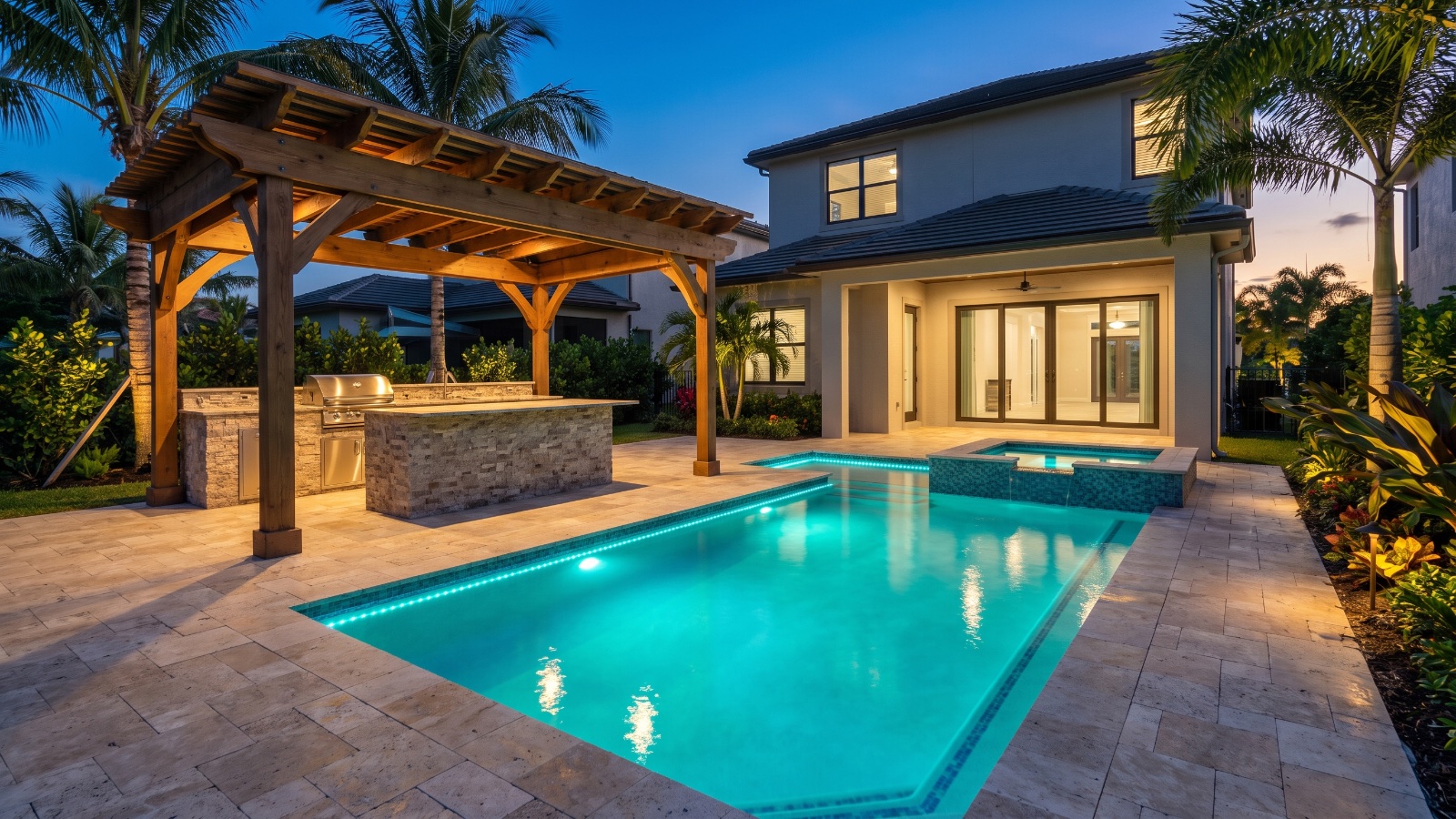 Finished Kingfisher custom pool and outdoor living space at dusk